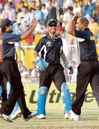 India Blue captain Virender Sehwag (right) celebrates with Dinesh Karthik (centre) and Neeraj Patel during the Challenger Trophy final against India Red at Motera, near Ahmedabad