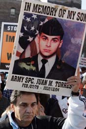Juan Torres of Chicago holds a poster of his son as he marches with thousands of anti-war protesters through the streets of Chicago on Saturday.