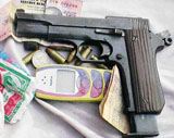 One of the pistols, a few cartridges and a mobile phone recovered from the gangsters killed in an encounter at Narnaund in Hisar district on Monday.