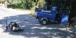The scene after an accident involving an auto-rickshaw and a motor cycle 