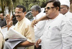 Karnataka BJP president Sadanand Gowda, and JD(S) state president Mirajudin Patel (right) and HD Revanna arrive to meet the Governor in Bangalore on Monday.