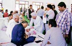 Aspirants filing in application forms for the Congress ticket during the Kangra District Congress Committee meeting on Tuesday.