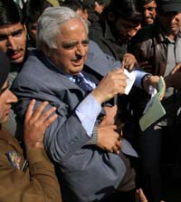 Former Chief Minister of Jammu and Kashmir and Peoples Democratic Party patron Mufti Mohammad Sayeed being pulled at by people demanding the redressal of their long-pending demands of civic amenities at Akar Phalgam in Anantnag district on Tuesday.
