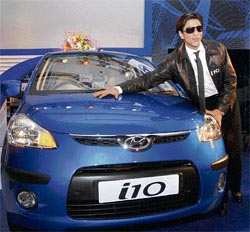 Bollywood star Shah Rukh Khan poses with Hyundai's new compact car 'i10' at its world premiere launch in New Delhi on Wednesday.