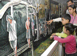 A volunteer explains an exhibit of India's freedom struggle in the Azadi Express, a train which reached Chandigarh on Wednesday.