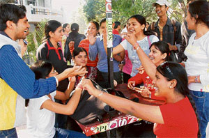 Students at PU students centre discuss poll strategies on the campus on Wednesday.