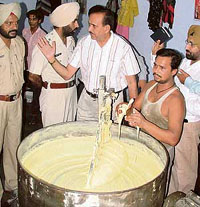 Civil surgeon S.P. Sharma with a team of policemen raid a shop while a worker was busy making synthetic khoya.