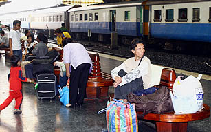 Passengers wait for their train following a strike at the Hualampong Station in Bangkok