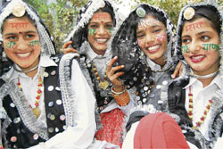 Students pose for photographers after performing a folk dance as part of the Haryana Day celebrations at Rajkiya Kanya Vidyalaya, Murthal Adda, Sonepat