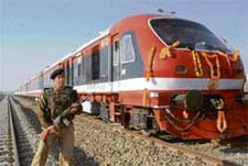 A jawan on guard at a railway station in Kashmir as a train hits the track between Kakpora and Budgam on Thursday. 