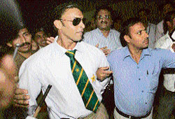 Pakistan fast bowler Shoaib Akhtar is escorted by security officials on his arrival at the Indira Gandhi International Airport in New Delhi