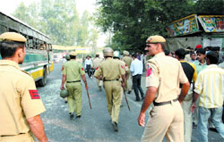 Policemen inspect the spot after a Blueline bus (route no. 621) ran over three persons in the R.K. Puram Area in the Capital