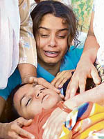 Relatives of victims of a road accident cry over the body of a child in Amritsar on Friday. 