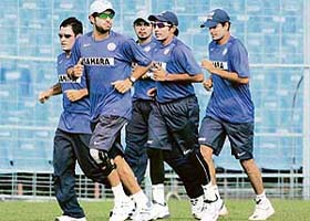 India's cricket players warm up (L-R) captain Mahendra Dhoni ,Yuvraj Singh, S Sreesanth, Robin Uthappa and Irfan Pathan during a cricket training session in Kolkata