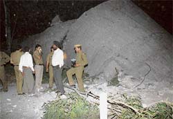 Officials from the fire and police departments inspect the site where a water tank collapsed in Phase I, Industrial Area, Chandigarh, on Sunday evening.