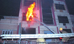 Firefighters try to douse a major fire which broke out at a commercial complex in Karol Bagh in the Capital on Sunday evening.