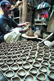 An artist gives shape to diyas ahead of Divali in the Capital on Sunday.