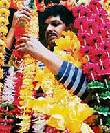 A shopkeeper arranges plastic flowers in Amritsar on Sunday. Flowers are in heavy demand throughout India ahead of Diwali.