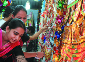 Women shop for decoratives for Divali in the Capital on Monday.
