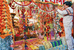 With Diwali just a few days away, a shopkeeper decks up his shop in Shimlas Lower Bazar