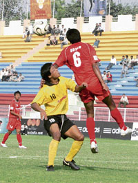 Players of Air India (yellow) and Churchill Brothers SC vie for ball during the first semifinal of Osians 120th Durand Cup Football Tournament at Ambedkar Stadium in New Delhi on Monday.