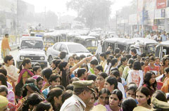 Girl students block traffic in Hisar on Tuesday after a girl was forcibly kissed by a fellow male college student.