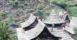 Devotees sacrifice a lamb on the temple roof.