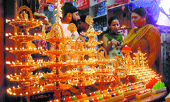Women enquire about colourfully lit lamps at a shop in Jalandhar