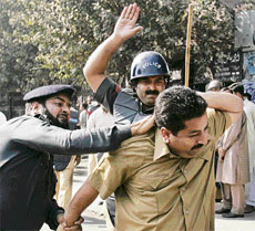Policemen beat up a protester in Lahore on Tuesday.