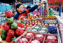 A boy stacks crackers on his stall at the ice skating ground in Shimla on Wednesday.