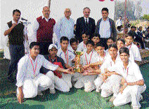 The winning team with the trophy.