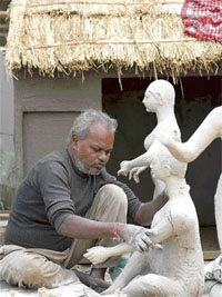 A craftsman makes statues for the Haryana pavilion at the India International Trade Fair in New Delhi on Saturday. The fair will be held from November 14 to 27.