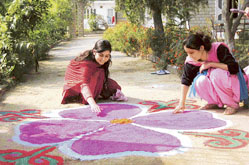 Such colourful rangolis are a common sight in front of houses on Diwali night. Two girls give finishing touches to a rangoli in Bilaspur