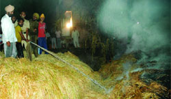 Locals dousing the flames at Baba Farid Nagar in Bathinda