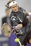 David Ferrer hits a return against Novak Djokovic in the second match of the Masters Cup in Shanghai