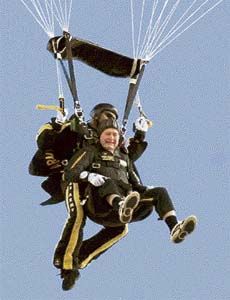 Former President George H.W. Bush makes his entrance to his presidential museum during a rededication ceremony