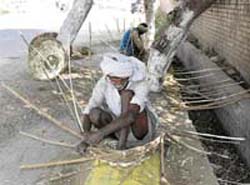 An old man makes baskets to earn his living on the Kunjpura road in Karnal. 