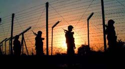 Soldiers of the Border Security Force (BSF) patrol on the Indo-Pak international border at Garkhal post in Akhnoor sector in Jammu. 