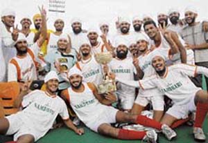 Namdhari players celebrate with the trophy after beating Indian Airlines in the final of the 37th SN Vohras All-India Gurmit Hockey Tournament at the Sector 42 Hockey Stadium in Chandigarh on Monday. 