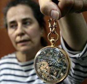 A woman holds up a pocket watch made for France's Marie Antoinette at Jerusalem's LA mayer Museum of Islamic Art