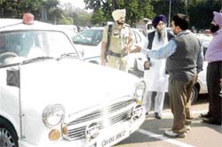 Punjab Co-operative Bank chairman is stopped by a municipal corporation employee from parking his car outside the bank office in Sector 17, Chandigarh, on Tuesday.