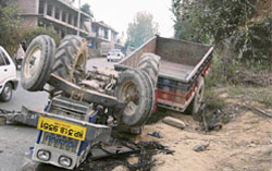 A tractor lies overturns at Tarot village, near Sundernagar