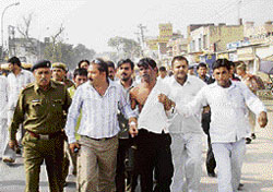 A youth being taken in procession by RSS activists for allegedly persuading people to convert to Christianity in Bhiwani on Wednesday.