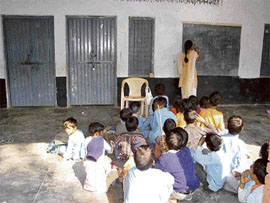 Pupils of Arriyanawala Government Primary School in Yamunanagar attend classes in the open on Wednesday as the classrooms were locked by the head teacher.