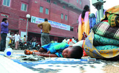 A child patient waits outside at Lok Nayak Hospital as the medical services were disrupted due to the strike of nurses in the Capital on Thursday.