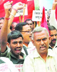 Activists of the joint action committee of national trade unions protest against assistant labour commissioner in front of his office in Jalandhar
