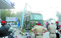 Civil and military police officials inspect the accident site at Rama Mandi chowk in Jalandhar on Thursday.