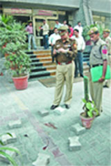 Delhi Police officials inspect the site near Antriksh Bhavan where a man committed suicide in the Capital 