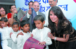 Actor Mahima Choudhary donates warm clothes to disabled children during the launch of Godrej Ezee, Rahaat-Ek Abhyaan, a winter wear donation drive in the Capital