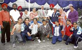 The winning team receives trophy during an athletics meet at Buddha Dal Public School in Patiala. 